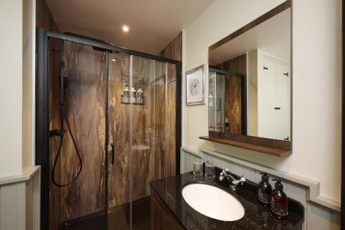 a bathroom with a sink and a shower at Middleton Farmhouse in Inverness