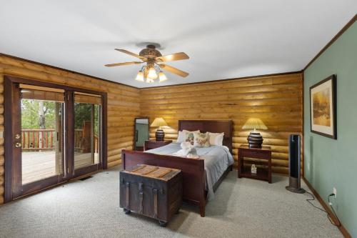 a bedroom with a bed and a ceiling fan at 13655 County Road 1 in Ridgway