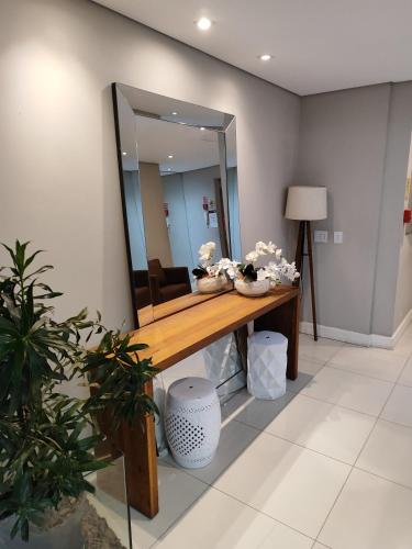 a mirror on a wall in a room at Areatricolor in Porto Alegre