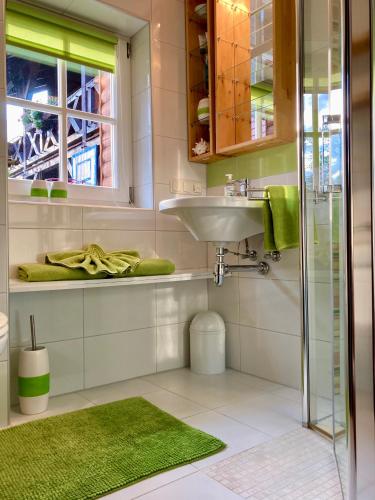 a bathroom with a sink and a shower at Ferienwohnung Crawissimo in Crawinkel