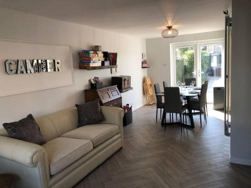 a living room with a couch and a table at Luxury House in Camber Sand Beach is 2min Walk !! in Rye