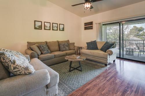 a living room with two couches and a table at Inviting Branson Condo with Community Pool and Hot Tub in Branson