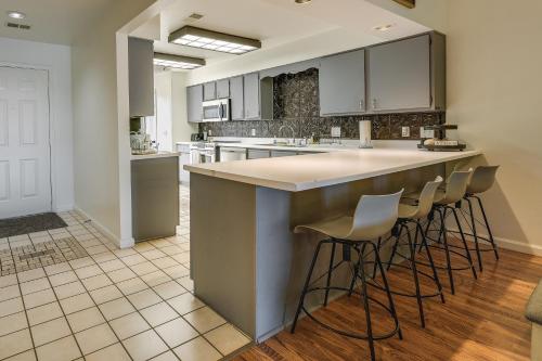 a kitchen with a island with bar stools at Inviting Branson Condo with Community Pool and Hot Tub in Branson