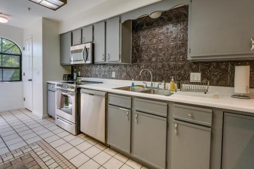 a kitchen with white cabinets and a sink at Inviting Branson Condo with Community Pool and Hot Tub in Branson