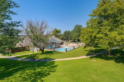 a house with a swimming pool in a yard at Inviting Branson Condo with Community Pool and Hot Tub in Branson