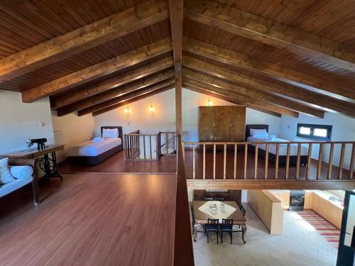 a large living room with a staircase and a living room at Zaros Cottage in Zarós