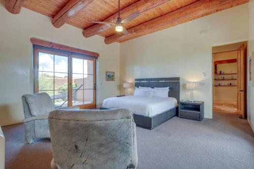 a bedroom with a bed and a chair and a window at Spacious Santa Fe Vacation Rental about 5 Mi to Town! in Santa Fe