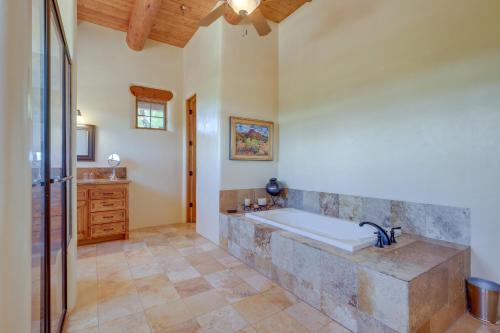 a large bathroom with a tub and a sink at Spacious Santa Fe Vacation Rental about 5 Mi to Town! in Santa Fe