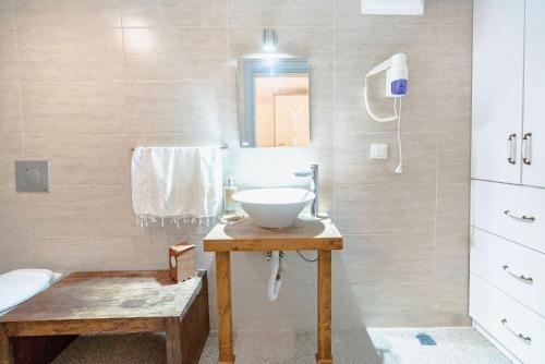 a bathroom with a sink and a mirror at niXie Hotel & Beach - Adult Only in Yalıkavak