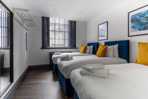 2 Betten in einem blau-weißen Zimmer in der Unterkunft Temple Court by UStay Aparthotels in Liverpool