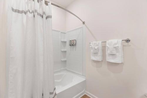 a white bathroom with a shower curtain and a sink at Modern Stylish Concord Condo in Concord