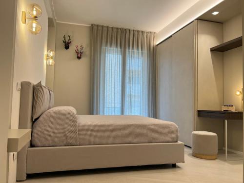 a bedroom with a large bed and a window at EMPATIA PESCARA CENTRO in Pescara