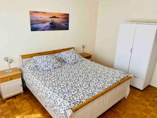 une chambre avec un lit et une commode dans l'établissement OPEN 24 7 Apartment parking 15' PARIS 3' ATHLETICA, à Saint-Gratien