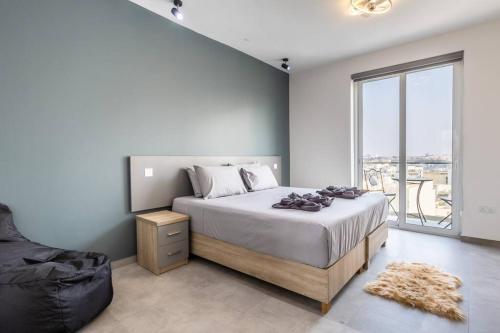 a bedroom with a large bed and a large window at Oasis Penthouse Luxury Suite by Solea in Sliema