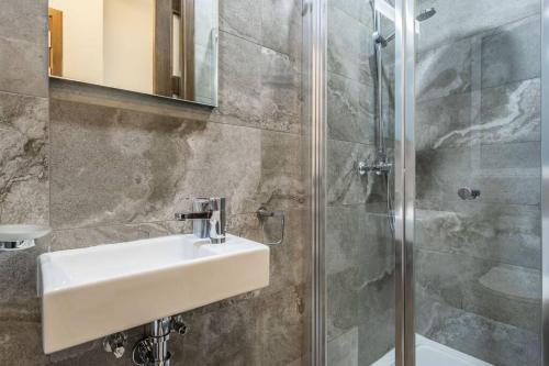 a bathroom with a sink and a shower at Oasis Penthouse Luxury Suite by Solea in Sliema