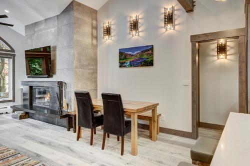 a dining room with a table and chairs and a fireplace at Fully Renovated 2 Bedroom in Arrowhead Village! condo in Edwards