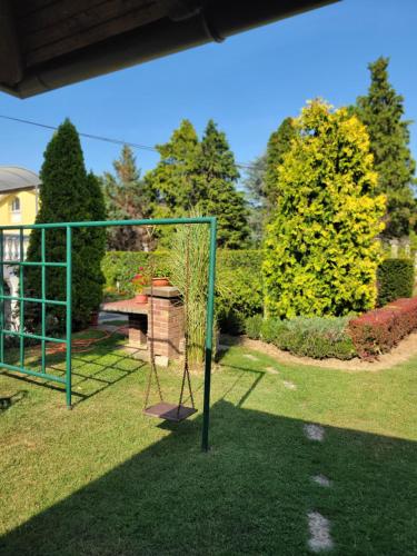a swing set in the grass in a yard at Green Garden Apartments in Surčin