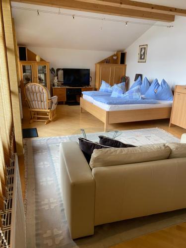 a living room with two beds and a couch at Appartement Schörghofer in Filzmoos