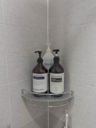 a shelf in a bathroom with two bottles of soap at KK Stay Ocean view with Netflix in Donghae
