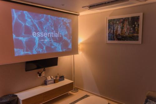a room with a projection screen on a wall at KK Stay Ocean view with Netflix in Donghae