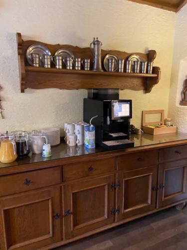 a counter with a coffee maker on top of it at Landhotel Kahrmühle in Pressath