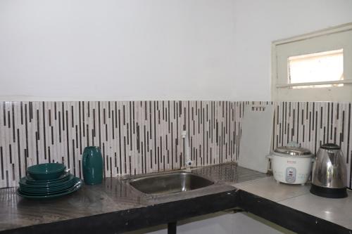 a kitchen with a sink and a counter top at Yellow Tree Thudugala in Kalutara