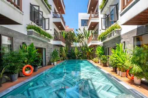 a swimming pool in the middle of a building at December Hoi An Villa in Hoi An