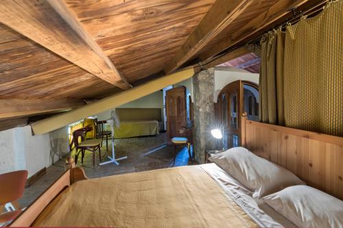 a bedroom with a large bed with a wooden ceiling at Relais Villa Giusso in Vico Equense