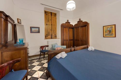 a bedroom with a blue bed with towels on it at Relais Villa Giusso in Vico Equense