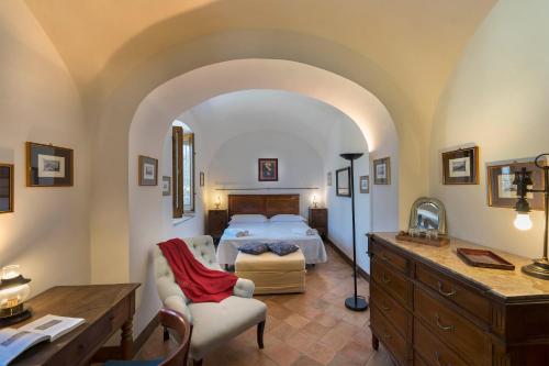 a bedroom with a bed and a desk in a room at Relais Villa Giusso in Vico Equense