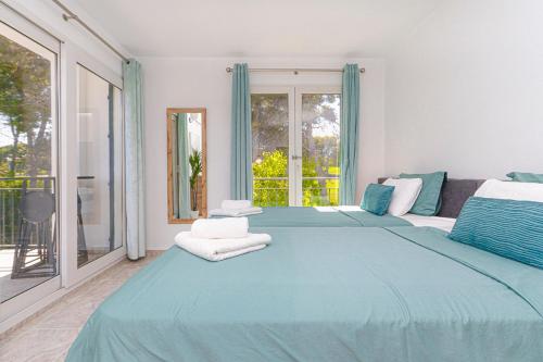 a bedroom with a large blue bed with towels on it at Presidential suite Villamartin Plaza First line Golf Quiet and confortable in Alicante