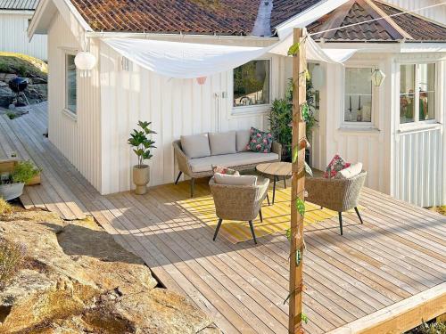 a patio with a couch and chairs on a wooden deck at 7 person holiday home in LJUNGSKILE-By Traum in Ljungskile