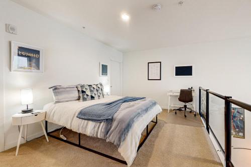 a bedroom with a bed and a desk at Central Loft in Seattle