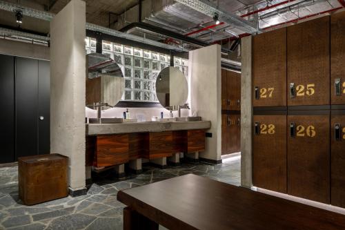 a bathroom with a sink and a large mirror at Mix Brussels --Gym & Wellness for adults only-- in Brussels