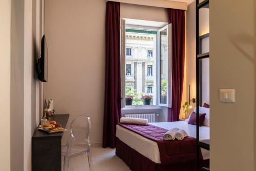 a hotel room with a bed and a window at Trastevere 143 in Rome