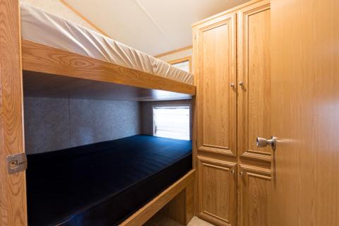 a small room with a bunk bed and a door at Point Sebago Resort in Casco