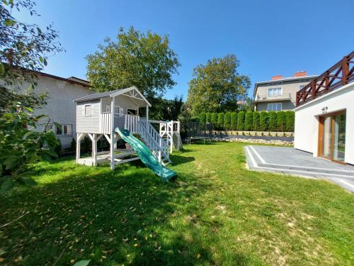 a playground in a yard with a slide at Agroturystyka Bliżej Natury in Rymanów-Zdrój