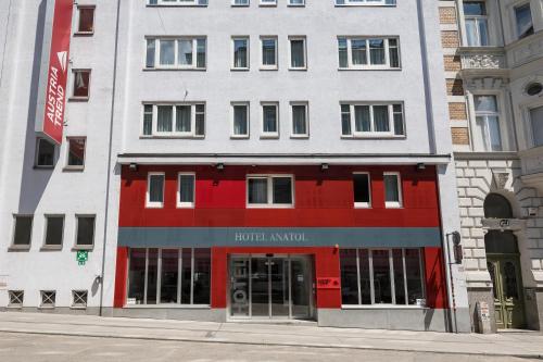 a building on a street with a hotel amazon at Austria Trend Hotel Anatol Wien in Vienna