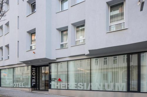 a facade of a building with glass windows at Austria Trend Hotel beim Theresianum Wien in Vienna
