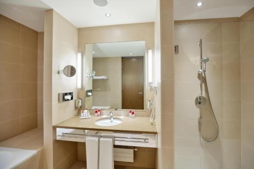 a bathroom with a sink and a shower at Austria Trend Hotel Savoyen Vienna - 4 stars superior in Vienna