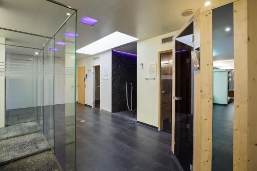 a hallway of an office with glass doors and stairs at Austria Trend Hotel Congress Innsbruck in Innsbruck