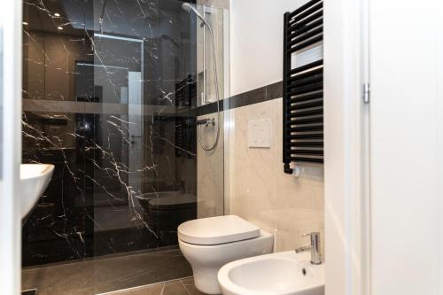 a bathroom with a toilet and a sink and a shower at Trastevere 143 in Rome