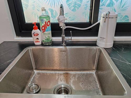 a sink in a kitchen with a window and a sink at Cozy 2room 7pax, Menara Sentral in Bukit Mertajam