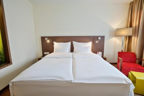 Ένα ή περισσότερα κρεβάτια σε δωμάτιο στο Austria Trend Hotel Doppio Wien