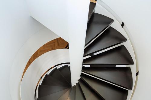 a spiral staircase with black and white treads at Austria Trend Parkhotel Schönbrunn Wien in Vienna