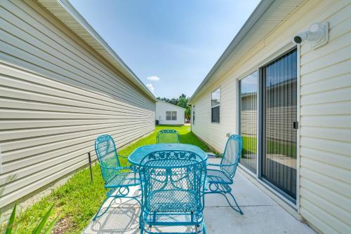 a patio with a table and chairs on the side of a building at The Villages Abode with Community Pools, Golf and More in The Villages