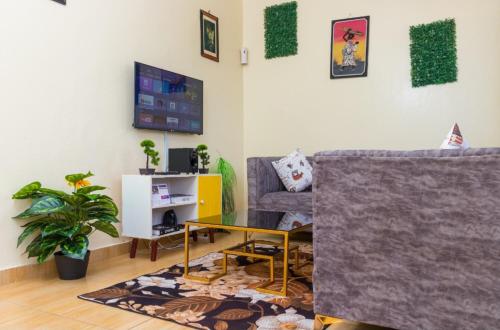 a living room with a couch and a table at loita apartment in Mombasa