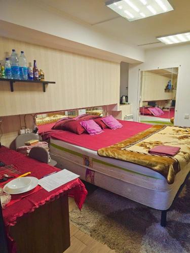 a large bedroom with two beds and a mirror at Апартаменты с трансфером in Chişinău