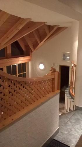 a room with a wooden staircase in a house at Haus Franziska in Kappl