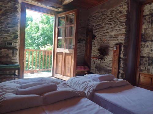a bedroom with a bed in front of a window at Albergo diffuso La Marmu Osteria della Croce Bianca in Marmora